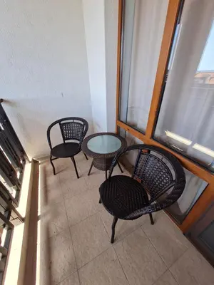 a balcony with two chairs and a glass table at MitProt Panorama Bay 2 luks Apartment 173 in Sveti Vlas