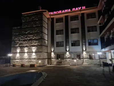 a building with a pool in front of it at night at MitProt Panorama Bay 2 luks Apartment 173 in Sveti Vlas