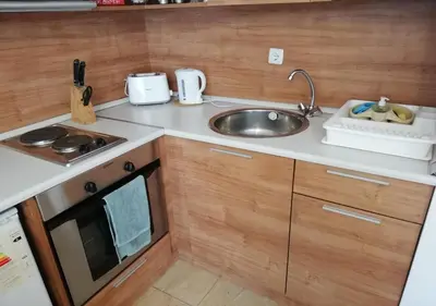 a small kitchen with a sink and a stove at Charis Cozy Family apart at Sun Village Complex close to the Beach in Sunny Beach