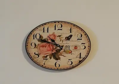 a clock on a wall with flowers and butterflies at Charis Cozy Family apart at Sun Village Complex close to the Beach in Sunny Beach