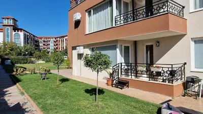 an apartment building with a balcony and a yard at Ferano Beach Apartments in Nesebar