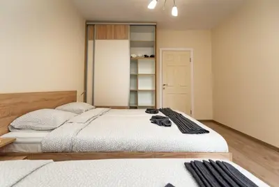 a bedroom with two beds and a closet at Apartment Galia in Burgas city center in Burgas City
