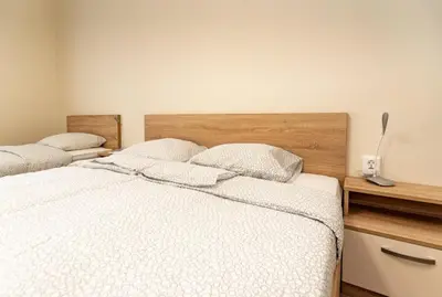 a bedroom with two beds with white sheets at Apartment Galia in Burgas city center in Burgas City