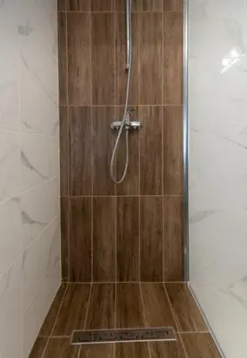 a shower with a glass door in a bathroom at Apartment Galia in Burgas city center in Burgas City