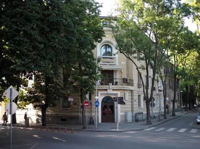 a building on the corner of a street in front of a road at San Stefano Elite Apartment in Varna City