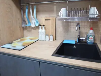 a kitchen with a sink and a counter with utensils at San Stefano Elite Apartment in Varna City