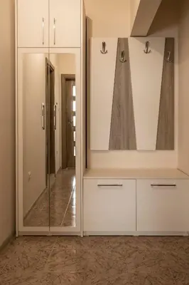 a dressing room with white cabinets and a mirror at Margis Home in Burgas City