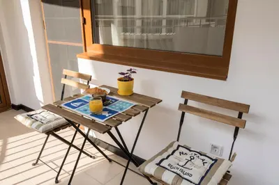 a small table and two chairs on a balcony at Margis Home in Burgas City