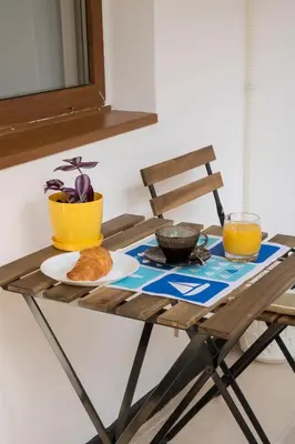 a wooden table with a plate of food on it at Margis Home in Burgas City