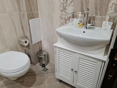 a bathroom with a white sink and a toilet at Ilarion 5 studio at Top Center in Varna City