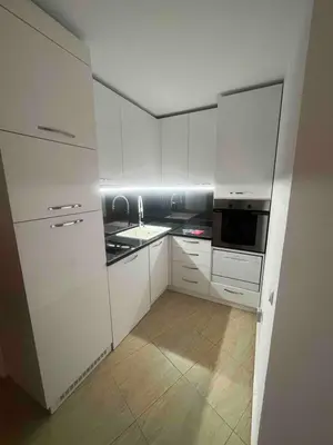 a kitchen with white cabinets and a sink and a microwave at Apartment in Sunny beach, Complex Sun Village, 80 qm, 2 bedrooms & living room near to the beach, SWIMMING POOL, garden in Sunny Beach