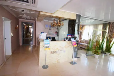 a hotel lobby with a reception desk in the middle at Menada Harmony Suites X in Burgas City