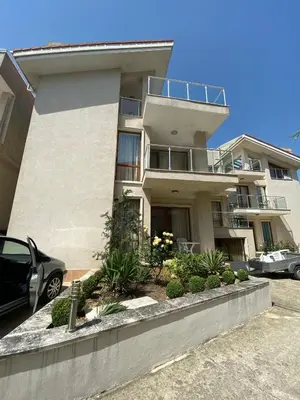 a building with a car parked in front of it at Beautiful Sun Village with sea view in Byala