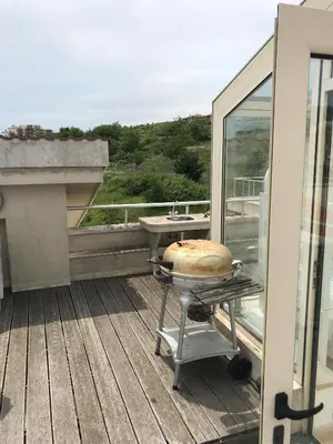a cake on a grill on top of a balcony at Sun Village Villa 13 in Byala