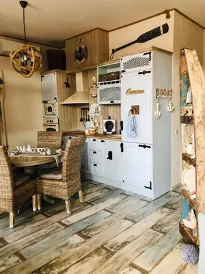 a kitchen with a table and wicker chairs at Arapya Beach Apartment in Tsarevo