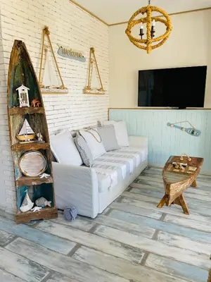 a living room with a white couch and a tv at Arapya Beach Apartment in Tsarevo