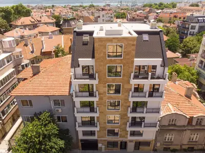 an apartment building in a city with roofs at La Familia Apartments in Varna City