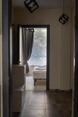 a view of a bedroom with a bed and a window at La Familia Apartments in Varna City