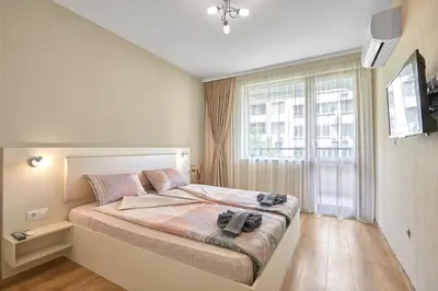 a bedroom with a bed and a large window at RELAX CENTER Burgas & Free PARKING in Burgas City