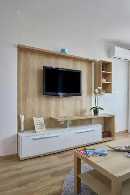 a living room with a flat screen tv on a wall at RELAX CENTER Burgas & Free PARKING in Burgas City