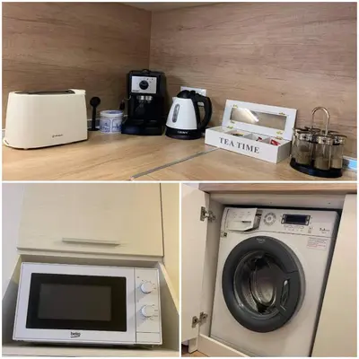 a kitchen with a microwave and a washing machine at RELAX CENTER Burgas & Free PARKING in Burgas City