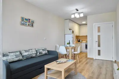 a living room with a couch and a table at RELAX CENTER Burgas & Free PARKING in Burgas City