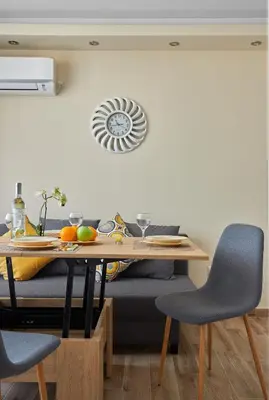 a dining room table with chairs and a table with fruit on it at ROMANCE APARTAMENT & Free Parking in Burgas City