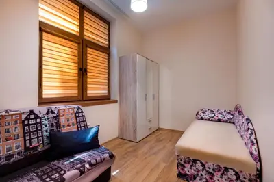 a living room with a couch and a chair at Family Apartment - COMFORT IN THE CENTER in Burgas City