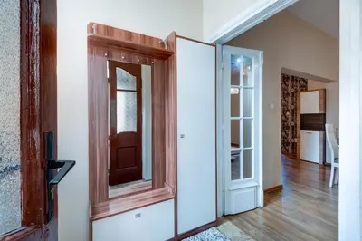 a mirror on a wall next to a door at Family Apartment - COMFORT IN THE CENTER in Burgas City