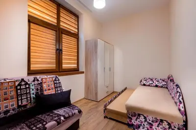 a living room with a couch and a window at Family Apartment - COMFORT IN THE CENTER in Burgas City