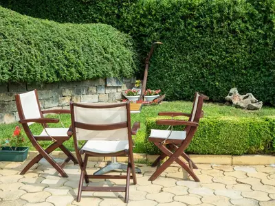two chairs and a table in a garden at Milennia Family Hotel in Sunny Beach