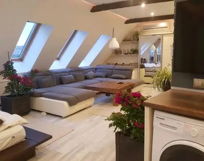 a living room with a blue couch and a table at Синьо лято in Burgas City