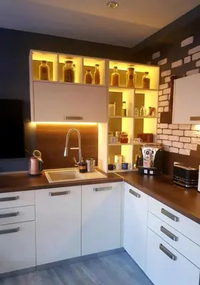 a kitchen with white cabinets and a sink at Синьо лято in Burgas City