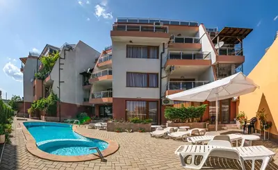 a hotel with a swimming pool and a building at The Monkee Studios in Sveti Vlas