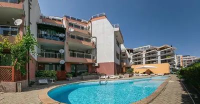 a swimming pool in front of some apartment buildings at The Monkee Studios in Sveti Vlas