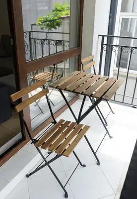 a wooden bench sitting on top of a balcony at Stylish Retreat High-end Flat Varna Downtown by Flat Mаnager in Varna City