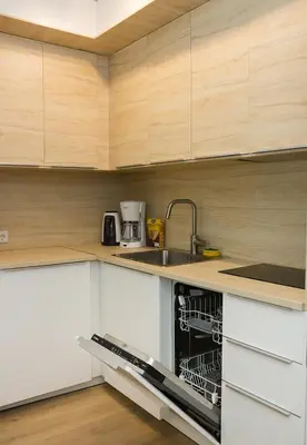 a kitchen with white cabinets and a dishwasher at Stylish Retreat High-end Flat Varna Downtown by Flat Mаnager in Varna City