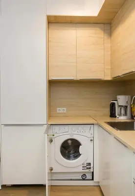 a kitchen with a washing machine in a kitchen at Stylish Retreat High-end Flat Varna Downtown by Flat Mаnager in Varna City