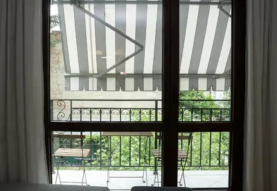an open window with a view of a balcony at Stylish Retreat High-end Flat Varna Downtown by Flat Mаnager in Varna City