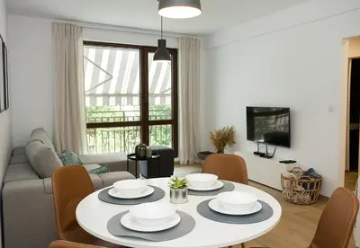 a living room with a table and a couch at Stylish Retreat High-end Flat Varna Downtown by Flat Mаnager in Varna City
