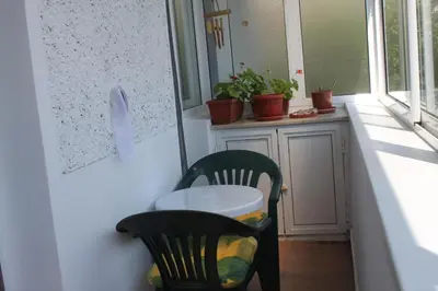 a table and two chairs in a room with a window at Sunny Cozy Flat in the Centre, close to beach, 4 rooms, 105sqm in Varna City