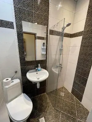 a bathroom with a toilet and a sink and a shower at Sunny Cozy Flat in the Centre, close to beach, 4 rooms, 105sqm in Varna City