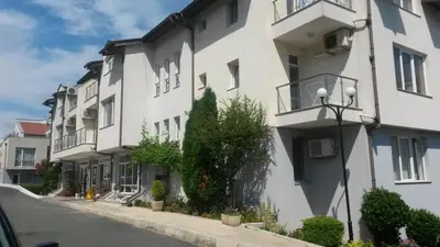 a row of apartment buildings on a street at Menada Apolon Apartments in Sozopol