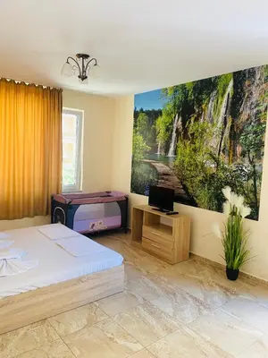 a room with two beds and a painting on the wall at Golden Sea View New in Pomorie