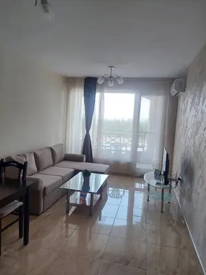 a living room with a couch and a table at Golden Sea View New in Pomorie