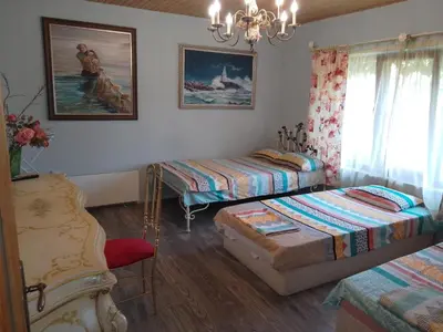 a bedroom with two twin beds and a chandelier at Guest House Amazonka in Varna City