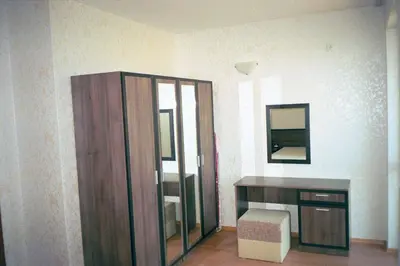 a room with a wooden cabinet and a mirror at Apartment Rutland Beach in Ravda