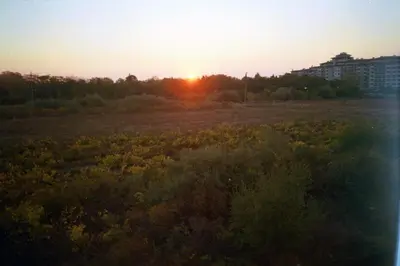 a field with the sunset in the background at Apartment Rutland Beach in Ravda