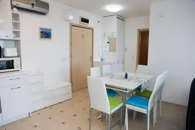 a kitchen and dining room with a table and chairs at Lux Sozopoli Hills Apartments A19 и Studio А13 in Sozopol