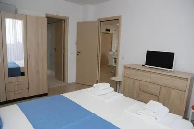 a bedroom with a bed and a tv on a cabinet at Lux Sozopoli Hills Apartments A19 и Studio А13 in Sozopol